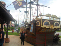 Danielle standing infront of a pirate ship on holiday